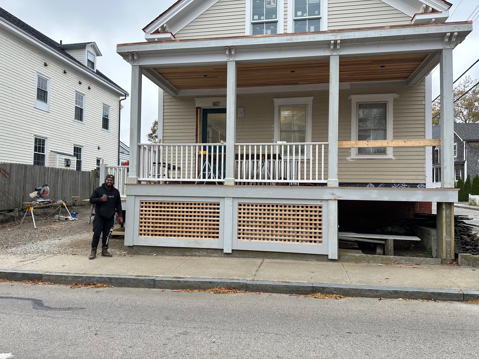 Restored colonial front porch with new railings and lattice skirting